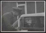 Photograph of Air force ROTC cadet talking to a woman and child in car